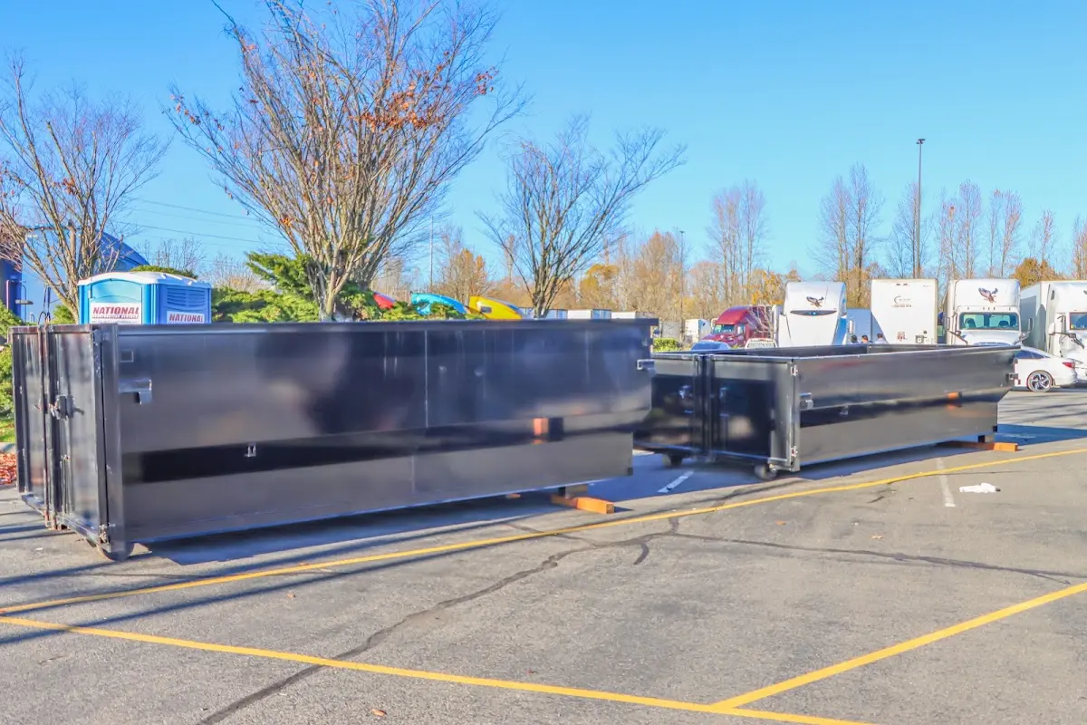 Professional dumpster rental service with roll-off container on residential driveway in Pinewood